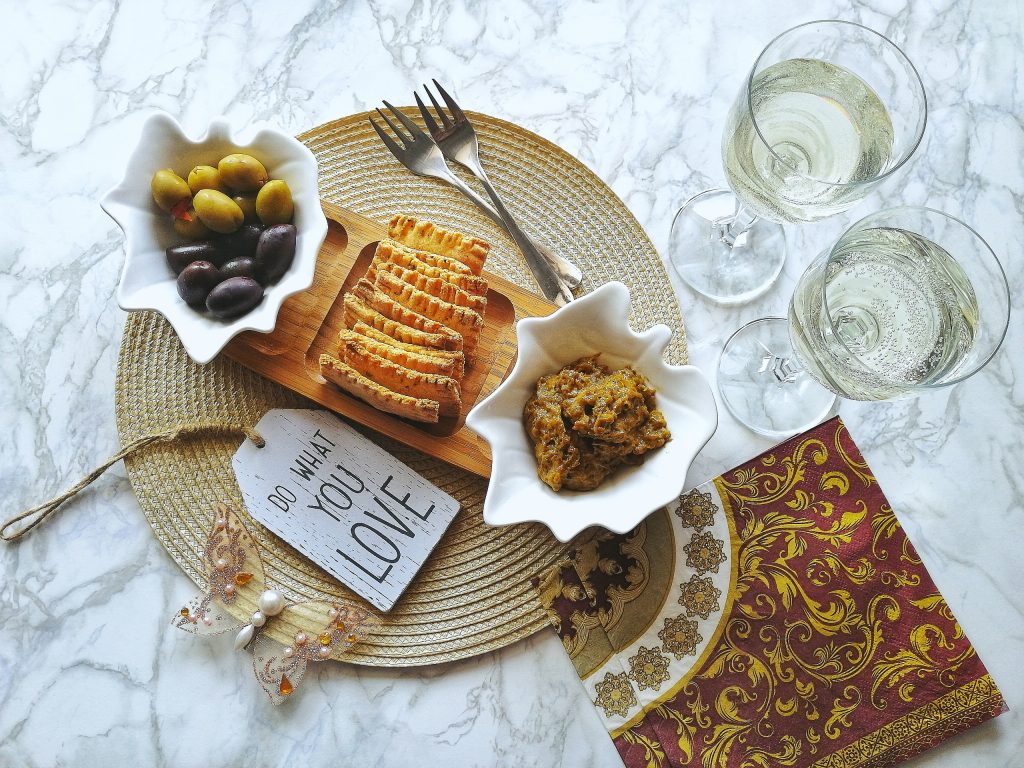 Crispy homemade vegan crackers served with olives and Macedonian malijano